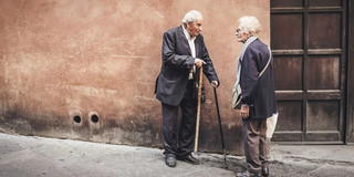 older man and woman talking