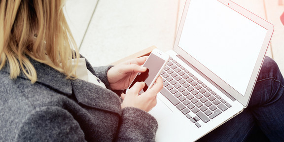 Frau mit Laptop auf den Beinen